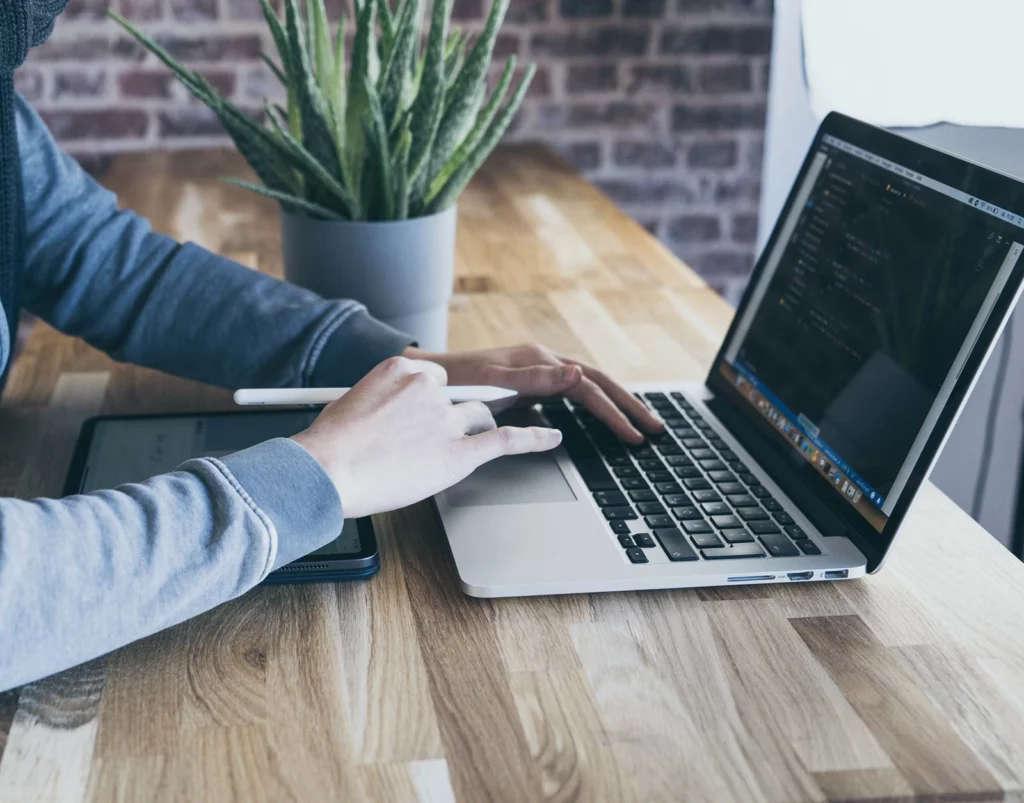 close up of man typing on laptop