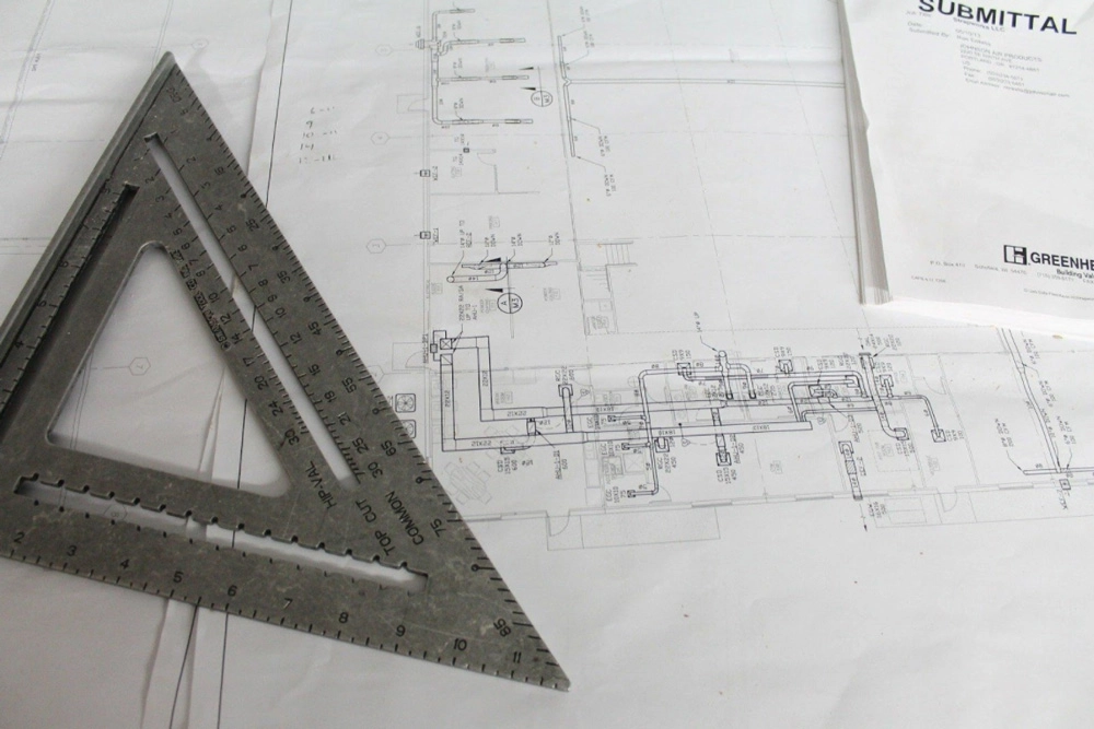 close up of a measuring tool and blue prints
