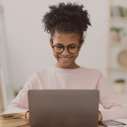 Teenage girl looking at laptop