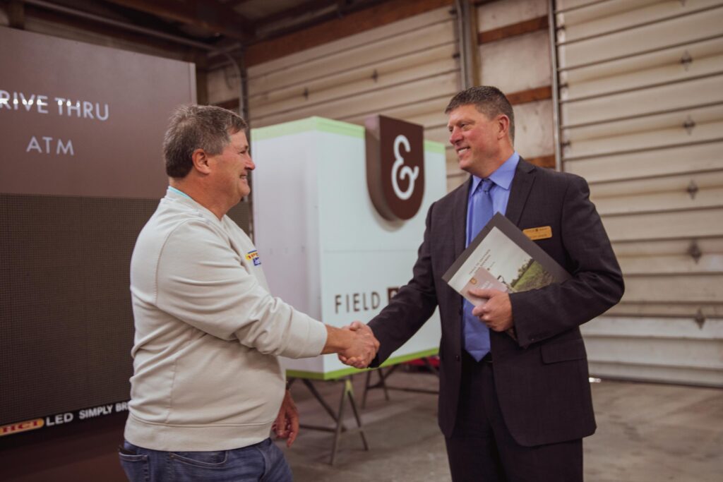 bank representative shaking hands with a small business owner