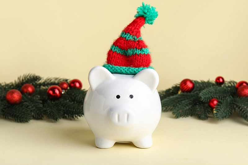 Piggy bank wearing a red and green hat
