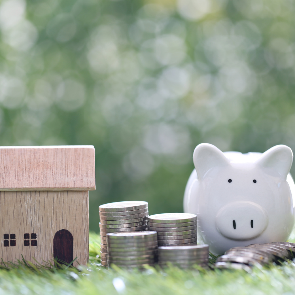 Model home with piggy bank and stack of coins Heloc