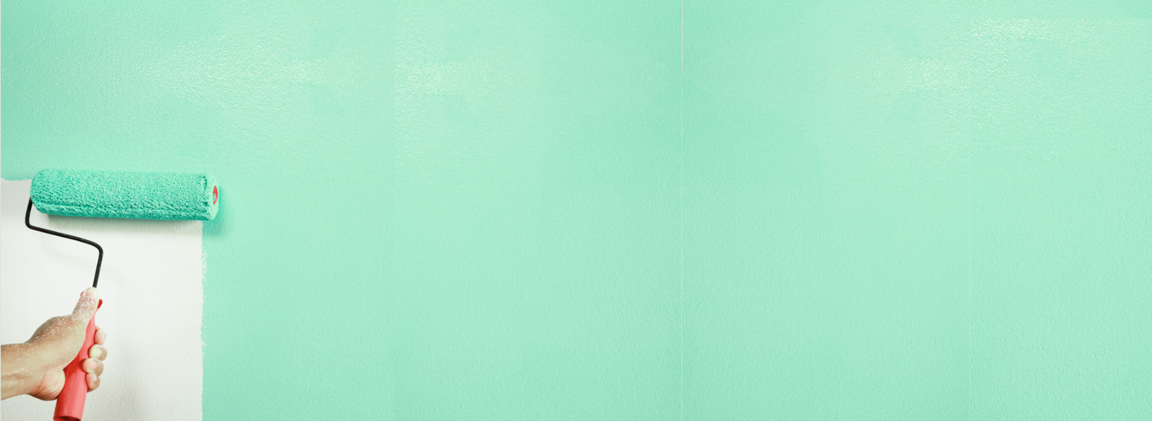 Person using a roller to paint a wall robin's-egg blue.